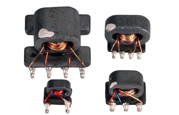 Four Balun transformers on white background